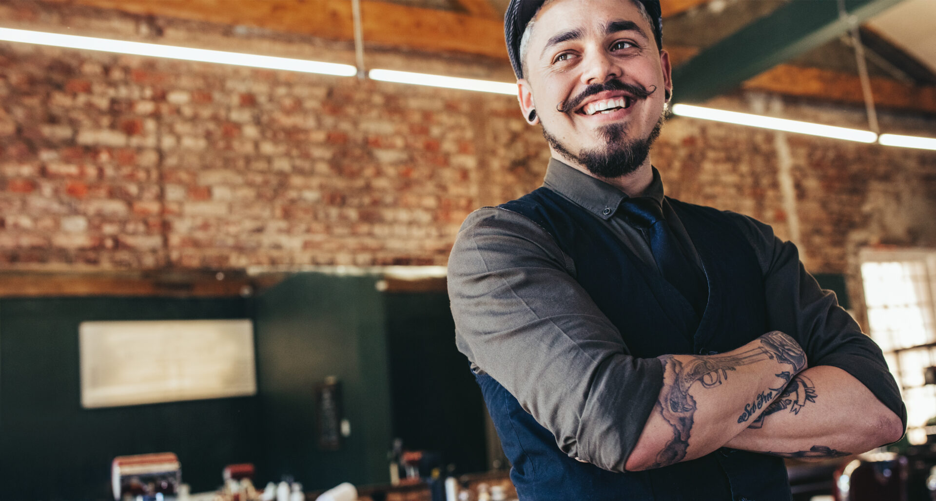 Close,Up,Of,Happy,Young,Male,Barber,With,Cap,Looking